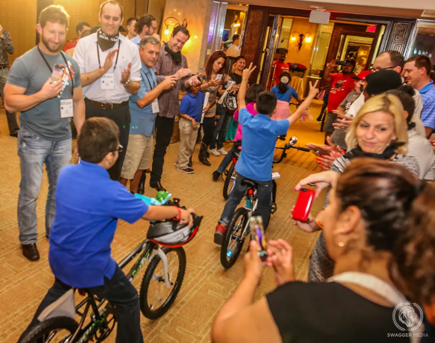 Kids riding bikes built during a conference service activity