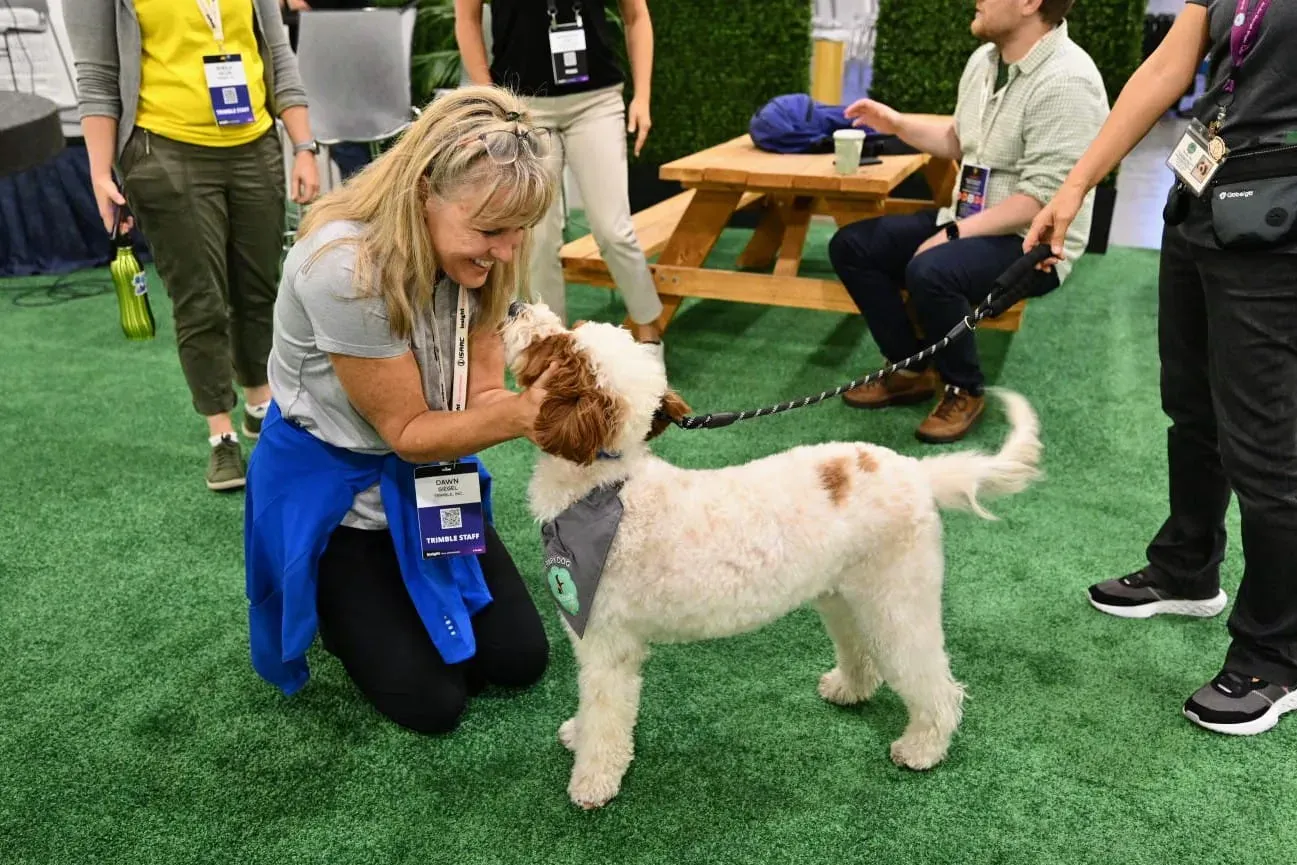 Therapy-dog moment on the exhibit floor at Trimble Insight, Las Vegas, 2024