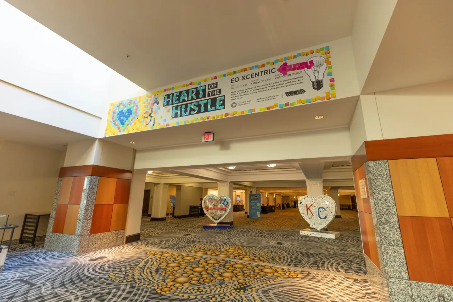 Heart of the Hustle entrance banner and photo hearts at EO XCentric, Kansas City, 2025
