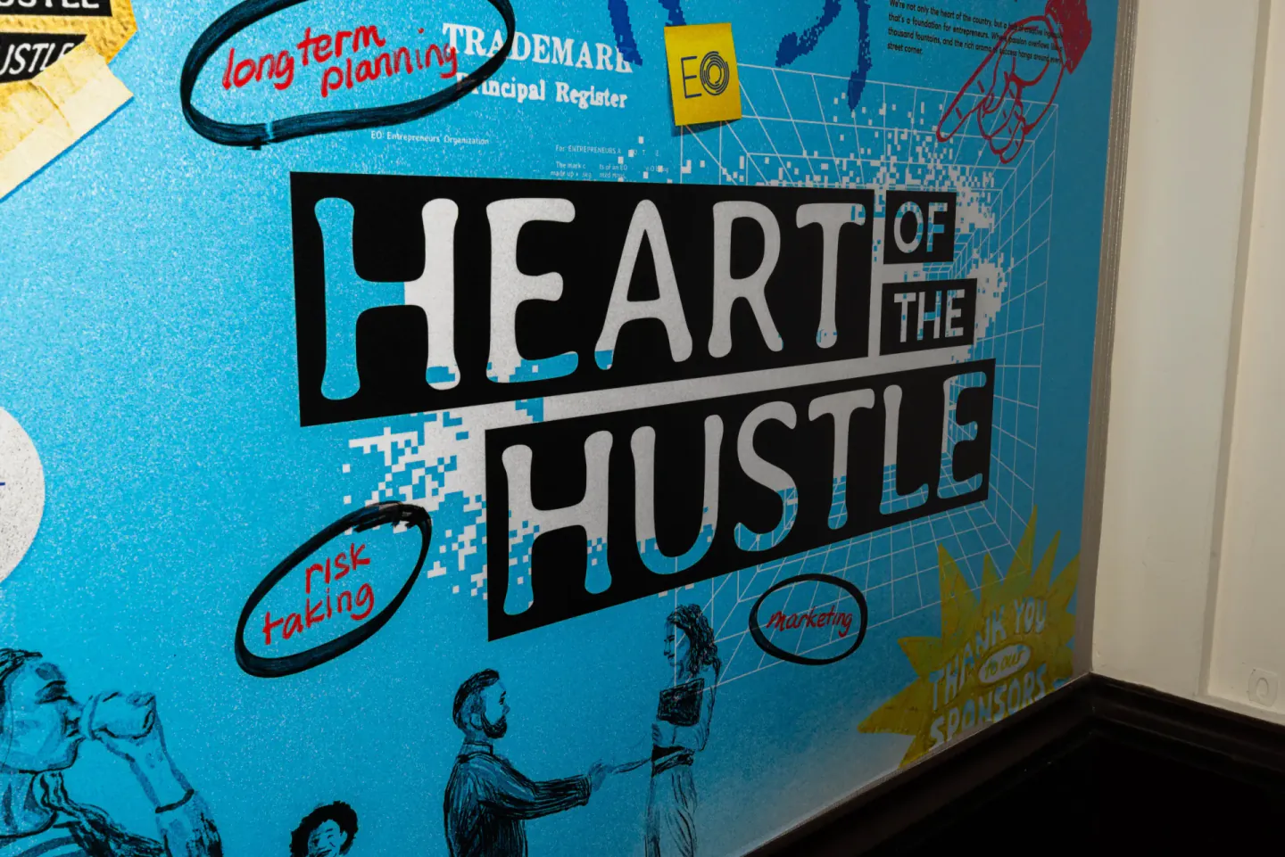 Heart of the Hustle illustrated wall graphic at EO XCentric, Kansas City, 2025