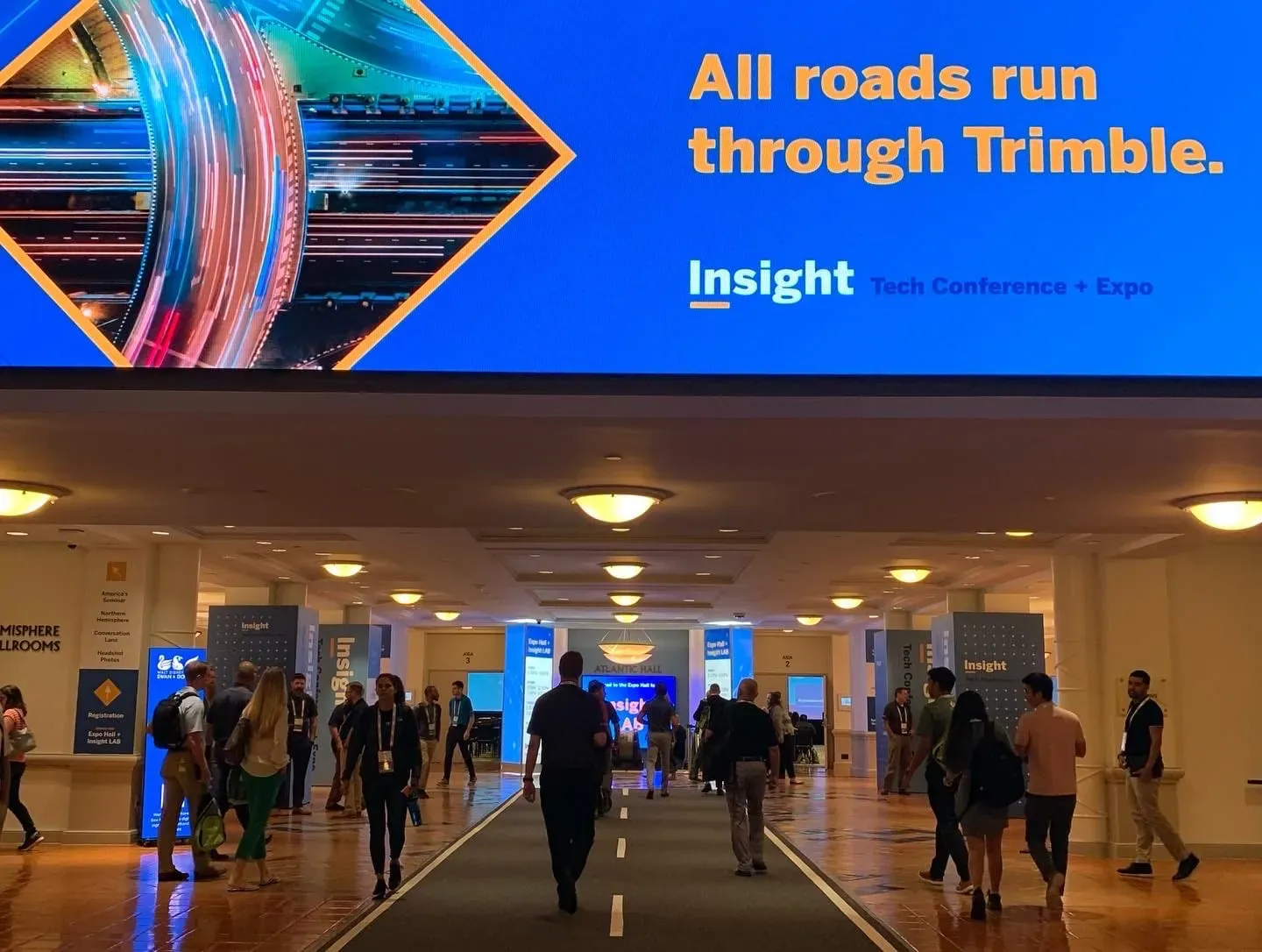 Overhead Insight screen and branded hallway at Trimble Insight, Orlando, 2022