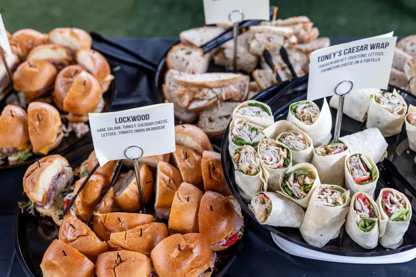 Sandwich and wrap platters with menu cards at EO XCentric, Detroit, 2023