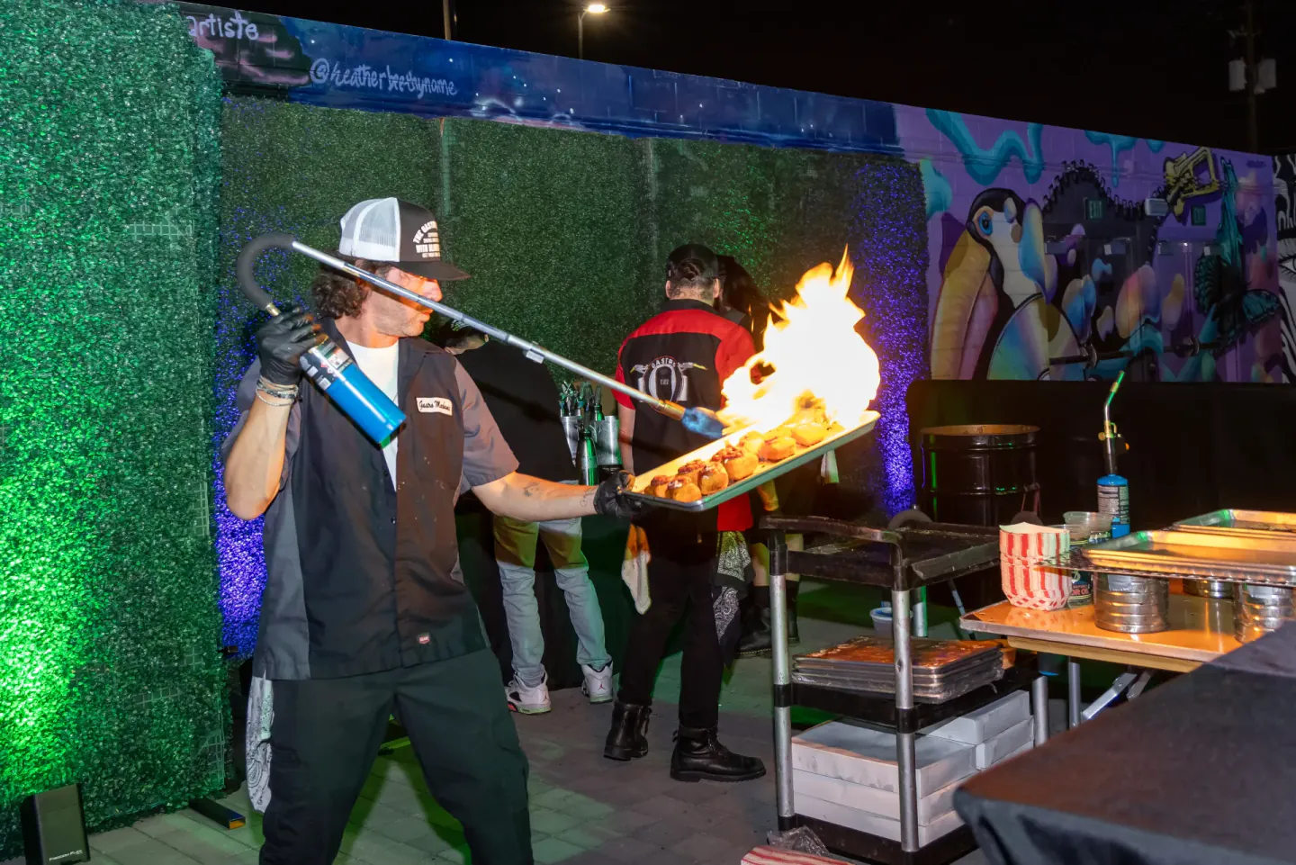 Chef finishing a dish with a torch at a live station, Trimble Insight, Las Vegas, 2023