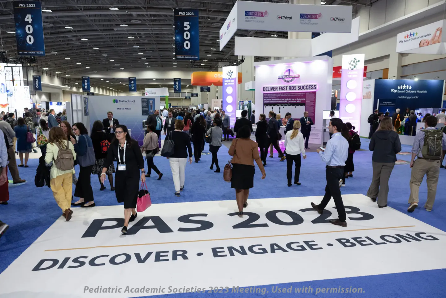 PAS 2023 exhibit hall with Discover Engage Belong floor graphic