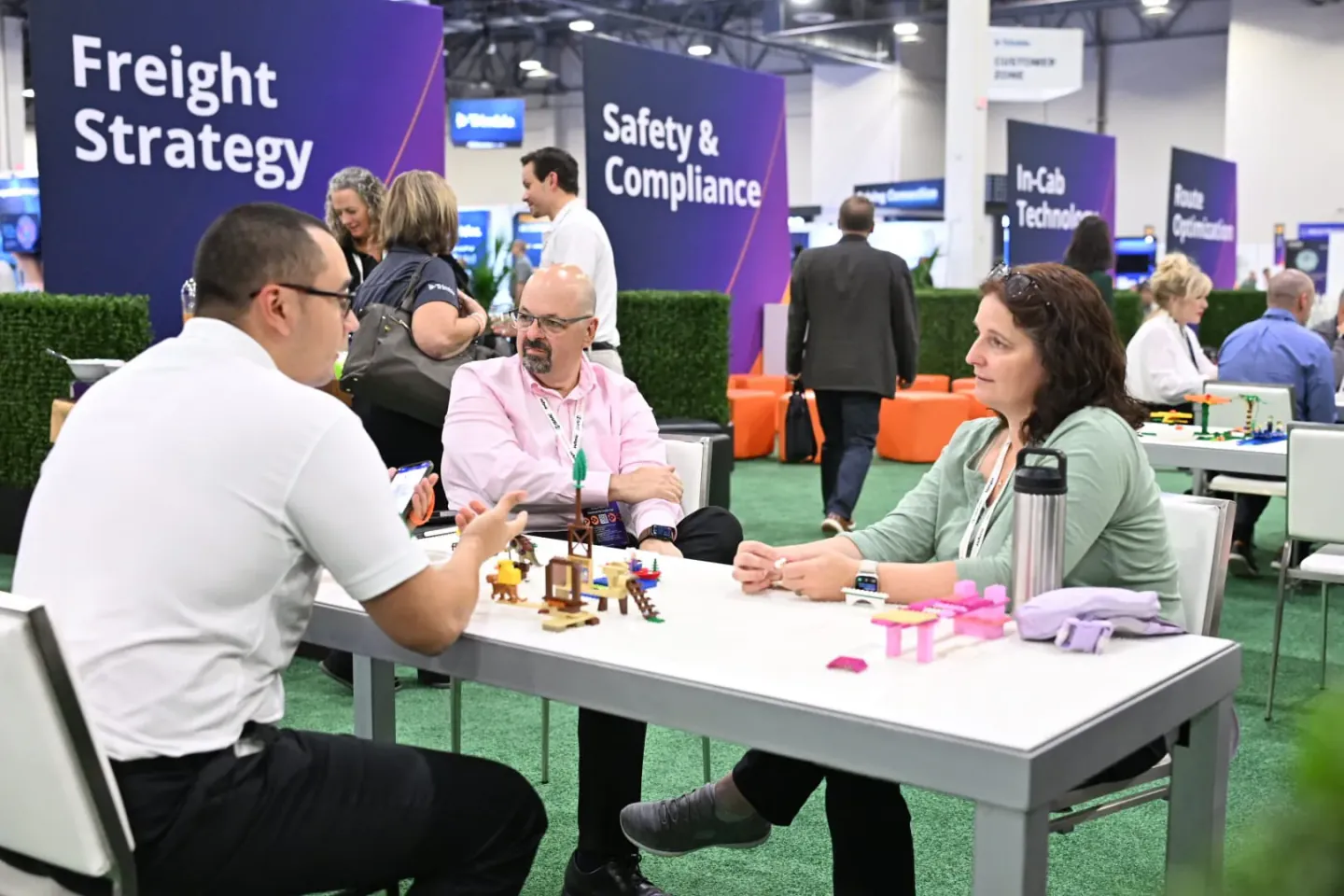 Networking tables among exhibit booths at Trimble Insight, Las Vegas, 2024