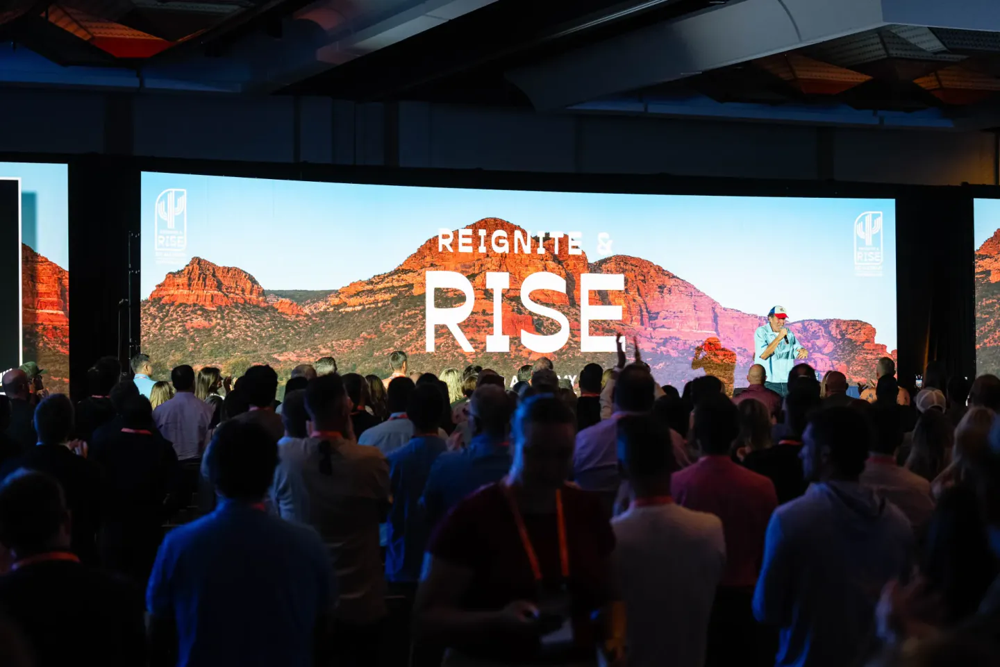 Reignite and Rise screen over a standing audience at EO Alchemy, Scottsdale, 2025
