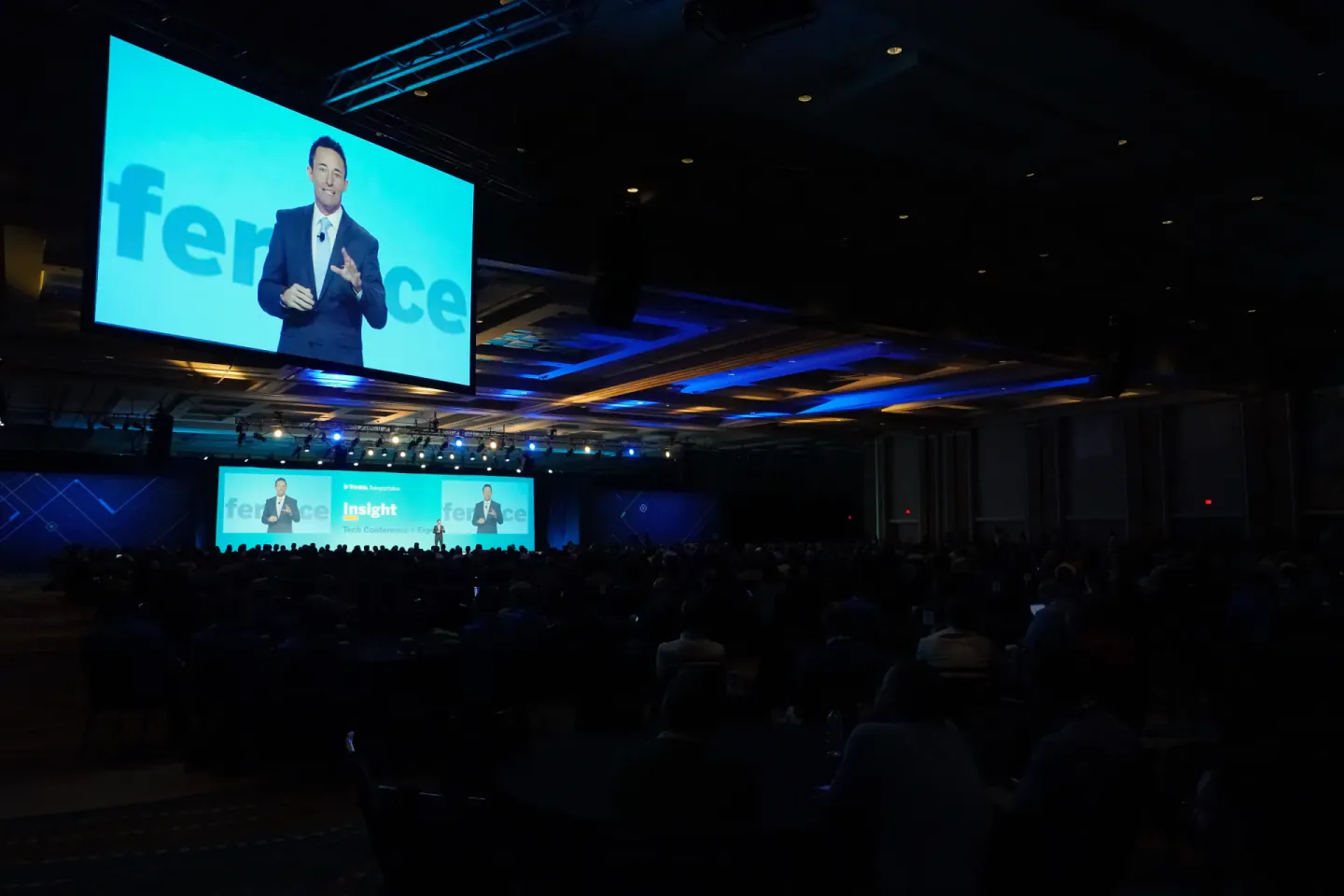 IMAG screens over a filled house at a Trimble Insight general session