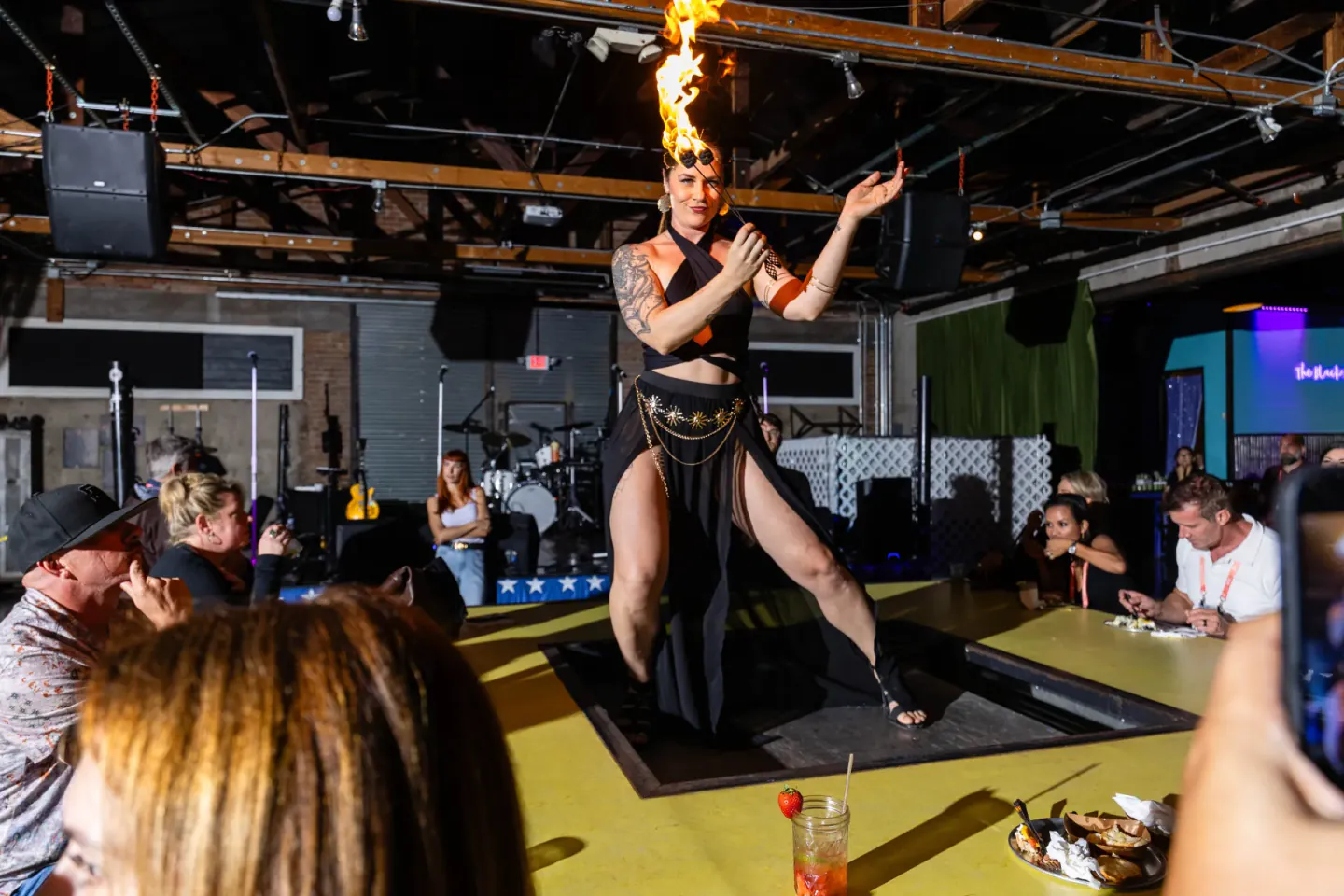 Fire performer over the dinner table at an evening event