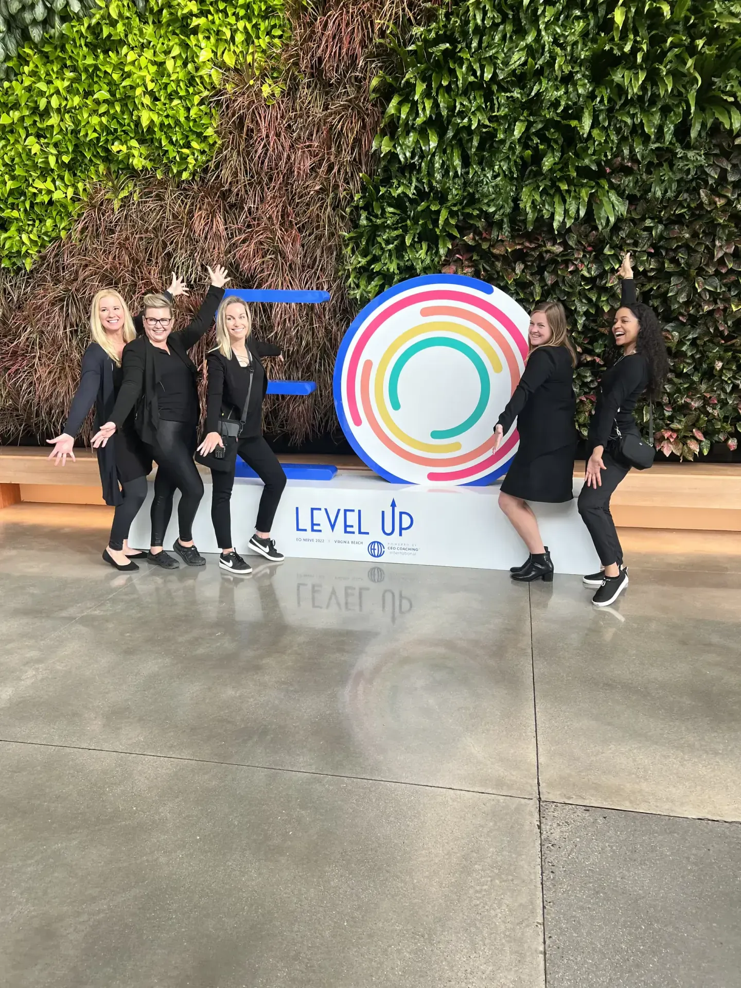 On-site team posing on the Level Up sign at EO NERVE, Virginia Beach, 2022
