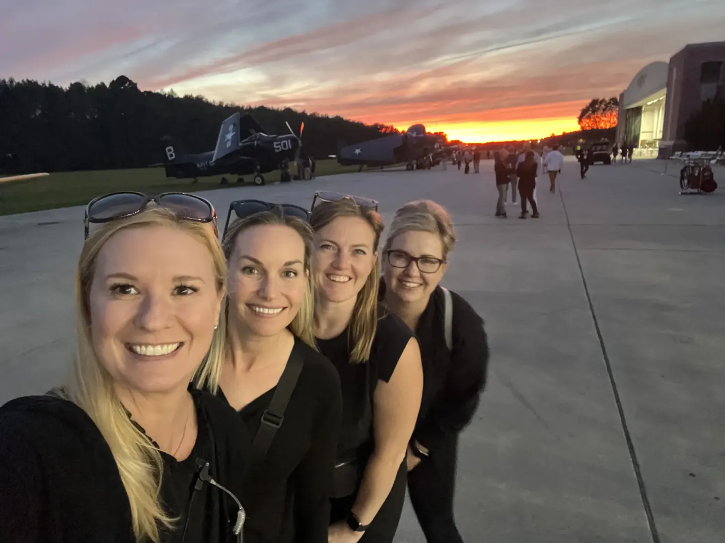 On-site team taking a sunset selfie on the tarmac at EO NERVE, Virginia Beach, 2022