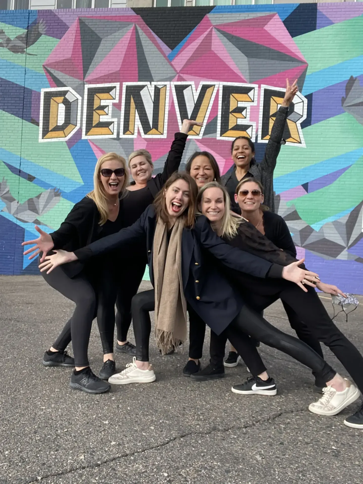 On-site team in front of a Denver mural at the PAS 2022 meeting