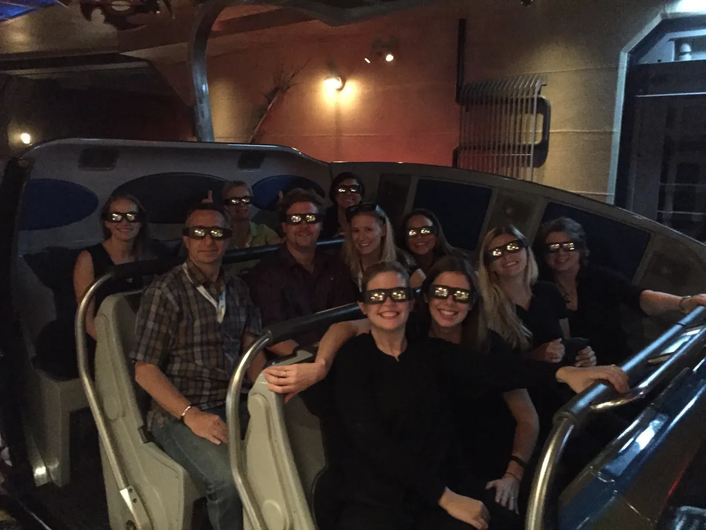 On-site team wearing 3D glasses on a motion-simulator ride
