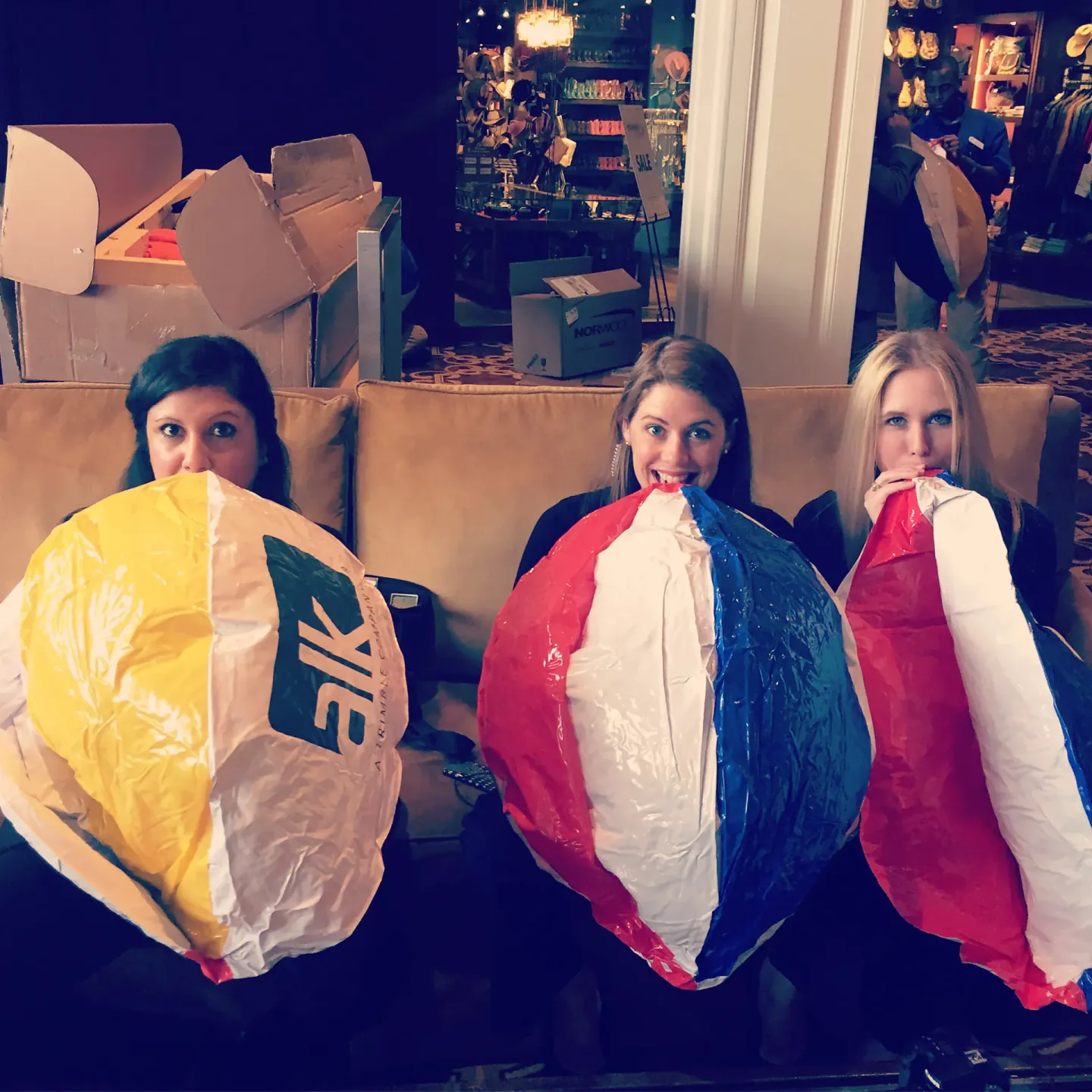 On-site staff inflating EIK beach balls backstage at a Trimble conference