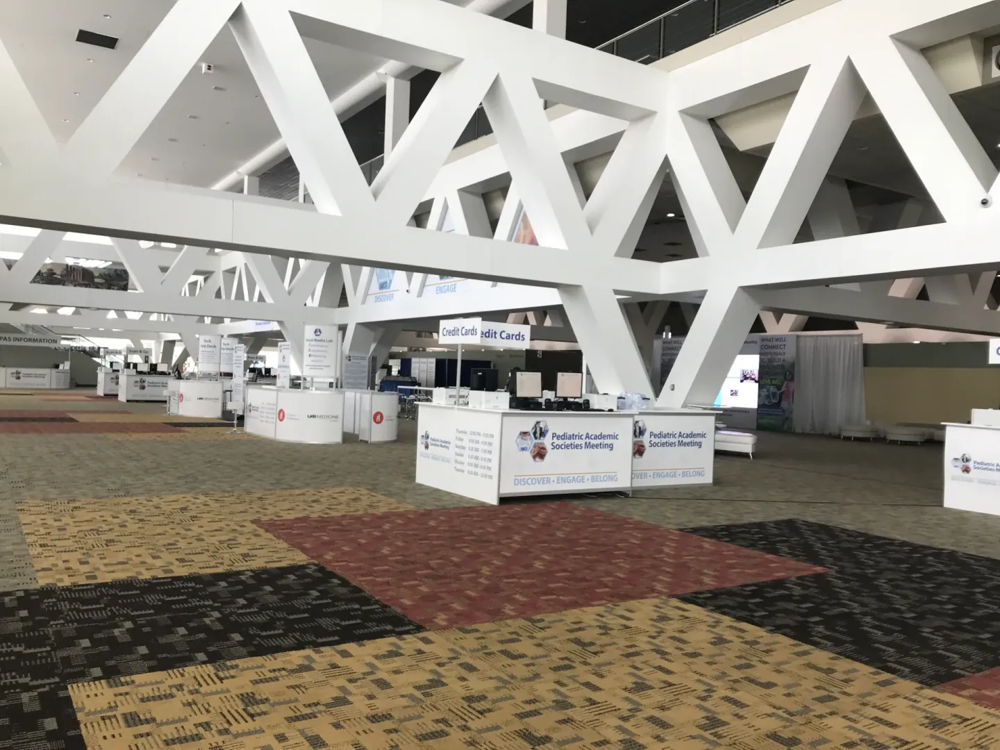 Registration kiosks and credit card desks in the concourse at a PAS meeting