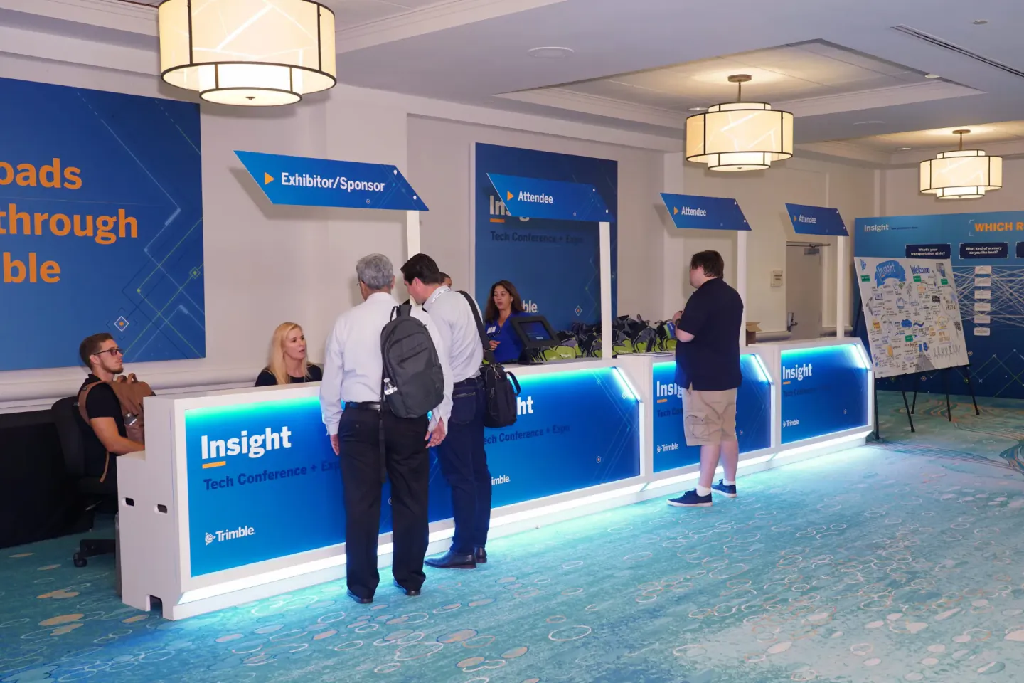 Trimble Insight Tech Conference + Expo registration desks with Exhibitor/Sponsor and Attendee lanes