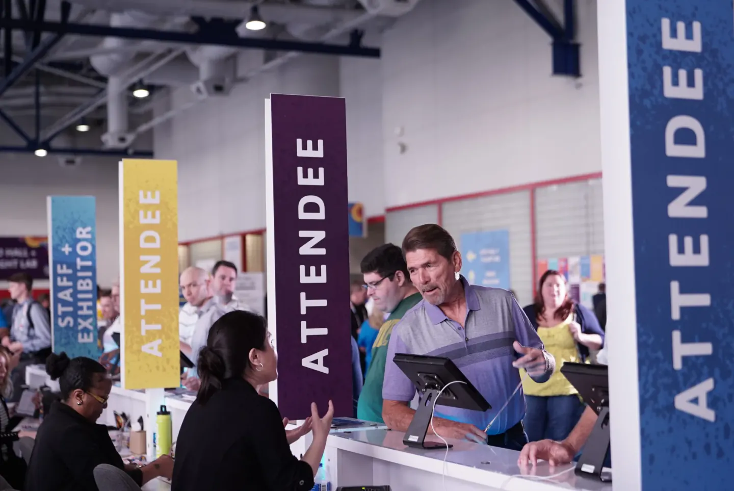 Attendee registration desk with Staff + Exhibitor and Attendee signs, Trimble Insight, Houston, 2018